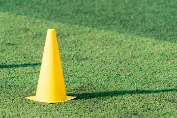 Yellow Soccer taining code on green artifact grass field