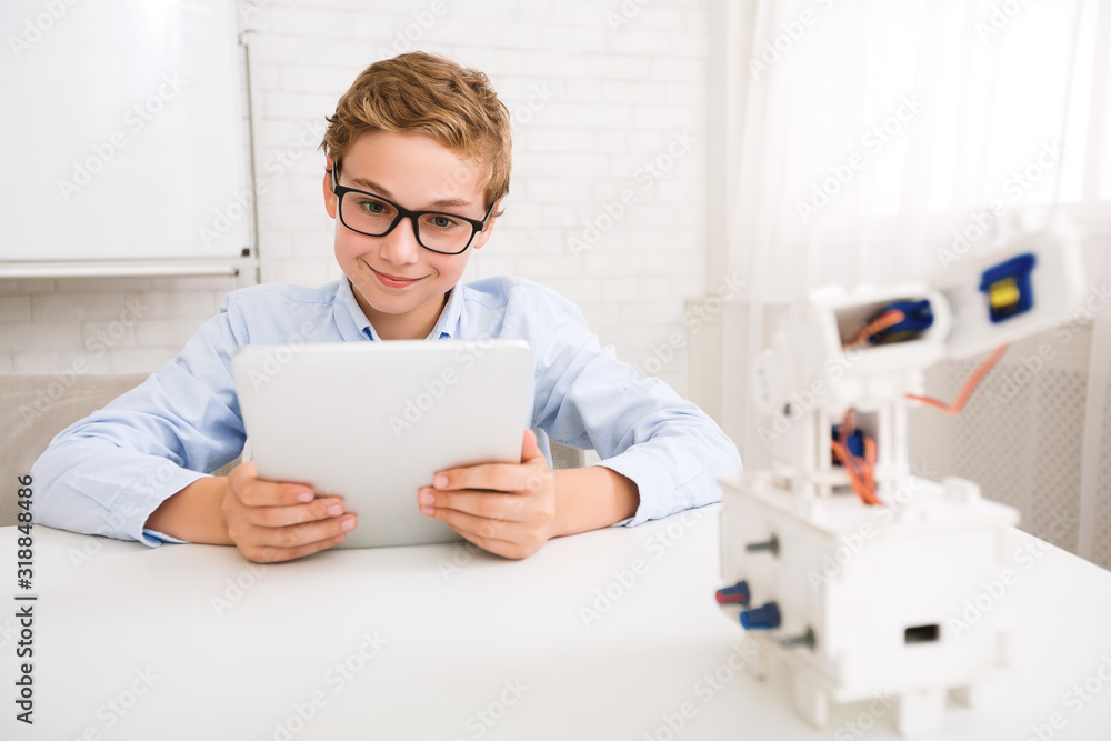 Poster Smart boy programming robot with tablet at stem educational lesson