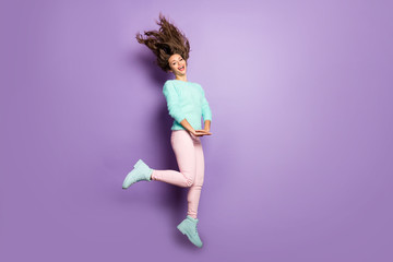 Fototapeta na wymiar Full length profile photo of funky lady jump high up good mood rejoicing hairstyle flying wear fuzzy sweater pastel pink pants footwear isolated purple color background
