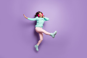 Fototapeta na wymiar Full body photo of pretty lady jumping high up excited good mood rejoicing dancing wear fuzzy pullover pink ear covers pastel pants boots isolated purple color background