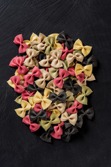 Top view of butterfly or farfalla pasta on dark backround.
