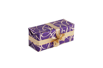 packaged rectangular gift in purple packaging with gold bow and gold pattern on the white background