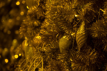 Lighting bulb and decorative golden pine tree Merry Christmas and Happy New Year for abstract background texture, Selective focus