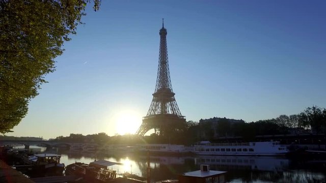 Silhouette of The Eiffel Tower in Paris, France over the River Seine. Filmed at dawn. Walking shot