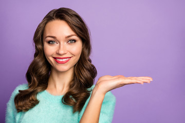 Closeup photo of pretty wavy lady hold open arm advising novelty product low shopping price wear casual teal fluffy pastel pullover isolated purple color background