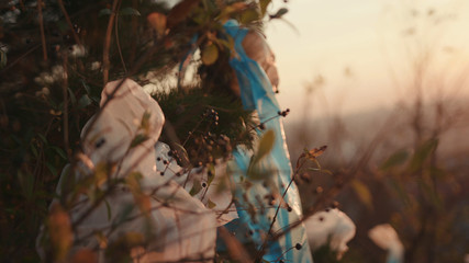 On tree plastic bag hanging on green in forest pollution ecosystem problem sweepings dump water bag garbage ecology environment trash waste dirty green rubbish contamination slow motion