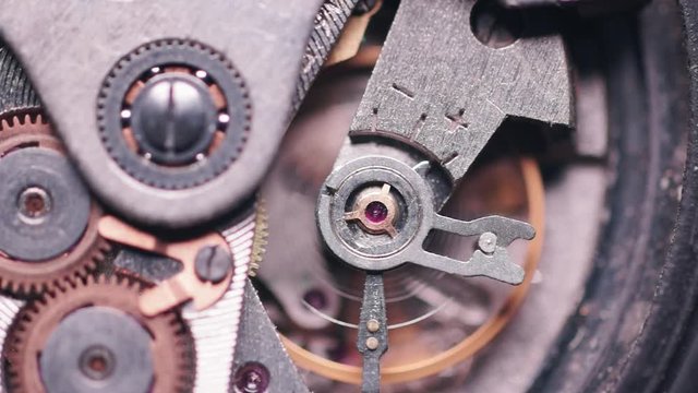 Vintage mechanical watch inside. Functioning mechanism of the clock, the movement of the pendulum. Macro video