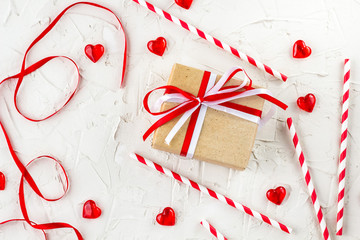 Flat lay for Valentine Day with red hearts, candles, confetti on white background.