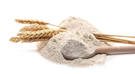 Barley flour and wheat ears with wooden spoon isolated on white background