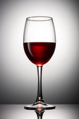 Glass of red wine on a grey background