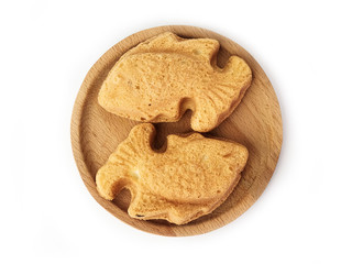 A Malay traditional cake called bahulu  in the form of goldfish over white background.