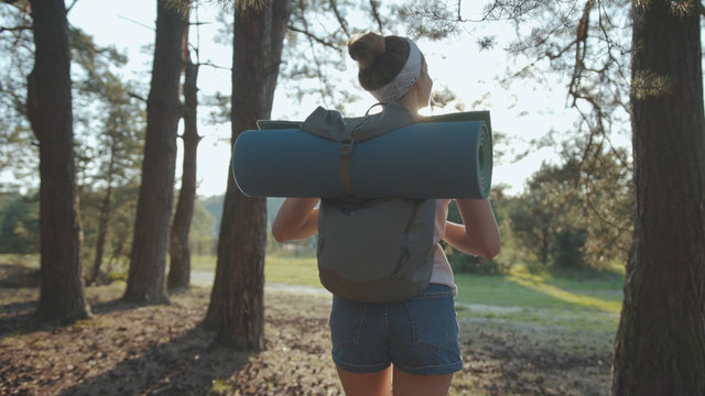 Shot Back Woman Young Tourist With Backpack Walking In The Fall Forest On Sunny Summer Day Smile Look Around Vacation Camping Hiking Travel Wood Hike Active Journey Young Nature Activity Slow Motion