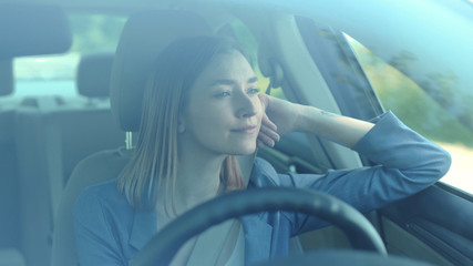Portrait of beautiful young woman driving car smile look around through big sunny face automobile road travel attractive emotional enjoyment freedom holiday moving outdoors slow motion