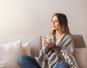 Peaceful girl enjoying hot coffee at home, empty space
