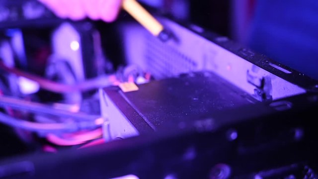 Checking power supply cord cables on a pc motherboard interior, purple light, slow motion