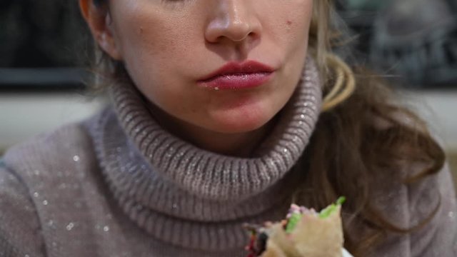 Woman eating a vegan wrap at business lunch