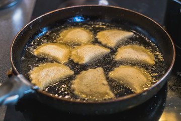fried Portuguese or Brazilian rissoles in a frying pan