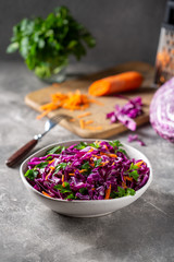 Red cabbage salad with carrots in a bowl.