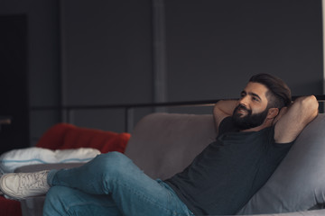 Obraz premium Young man sitting relaxing on the couch