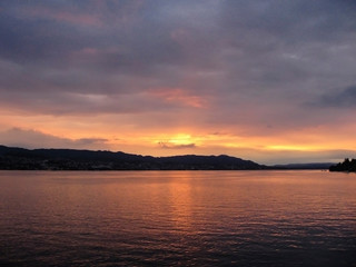 Fototapeta na wymiar Beautiful sunset at Lake Zurich with sun reflecting from water.