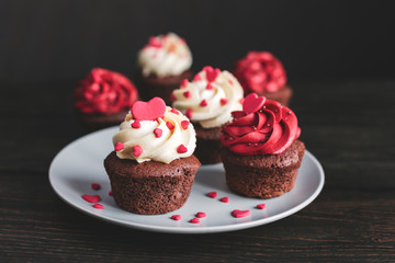 Valentine cupcakes, served on the plate and decorated with sweet hearts.
