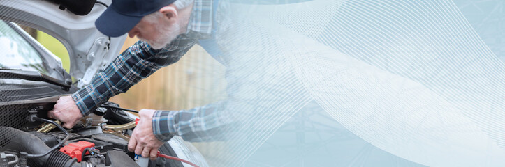 Car mechanic using car battery jumper cable; panoramic banner