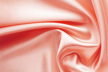 shining red fabric with large folds, textile background