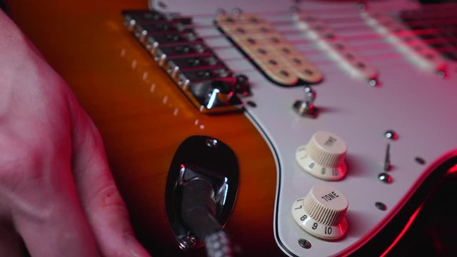 Close Up Of Hand Plug In The Aux In Electric Guitar