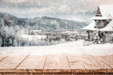 Wooden desk of free space and snow background 