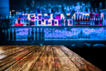 Desk of free space and blurred background of bar 