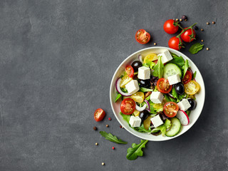 Greek salad with fresh vegetables, feta cheese and black olives