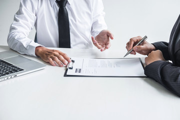 Employer or committee holding reading a resume with talking during about his profile of candidate,...