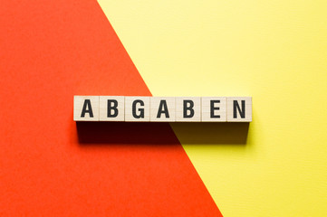 Abgaben word levy in german concept on cubes