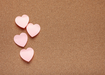 Cork board with heart stickers. Valentine's Day background.