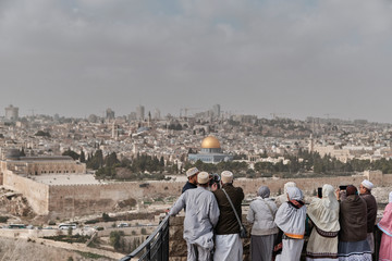 muslim group of tourist looking the Panoramic view to Jerusalem old city from the Mount of Olives, Israel - DEC 2019.