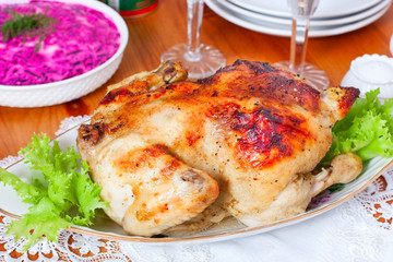 Whole baked chicken with apples on the festive table, selective focus