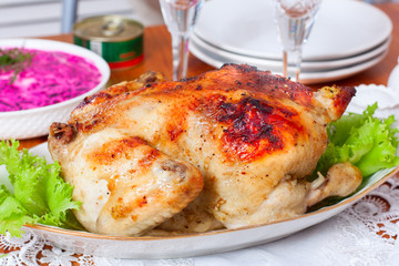 Whole baked chicken with apples on the festive table, selective focus