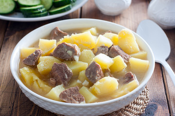 Beef stew with chopped beef in a white bowl, selective focus