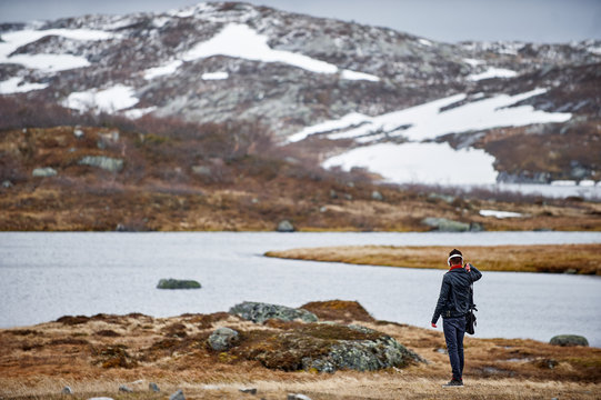 a man looks at the mountains in Norway