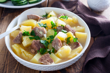 Beef stew with chopped beef in a white bowl, selective focus