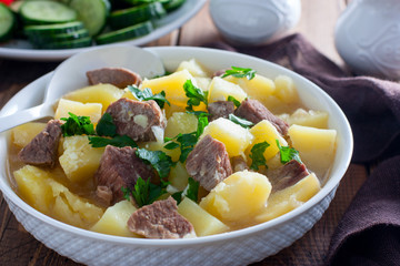 Beef stew with chopped beef in a white bowl, selective focus