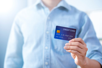 Man hand holding front credit card wear shirt