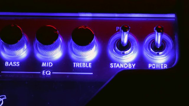 Close up of Hand Switch On and Off the Amplifier Power