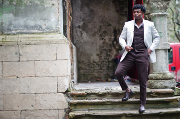 Thoughtful young handsome african american gentleman in formalwear. Black stylish model man in white jacket.