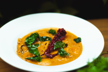 Thai Curry with vegetables on wooden table