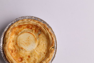 Delicious three cheese quiche in colored background