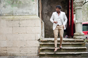 Thoughtful young handsome african american gentleman in formalwear. Black stylish model man in white jacket.