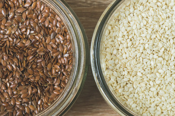 flax and sesame seeds in glass jars top view