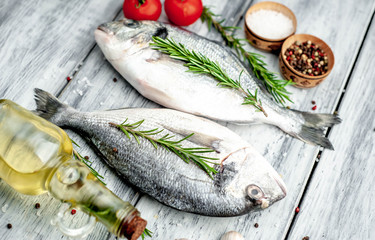  Fresh dorado fish with spices and ingredients for cooking on a wooden table background