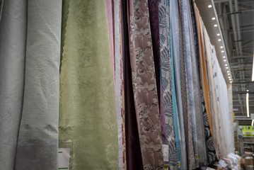 Curtains of different colors and styles in the shop